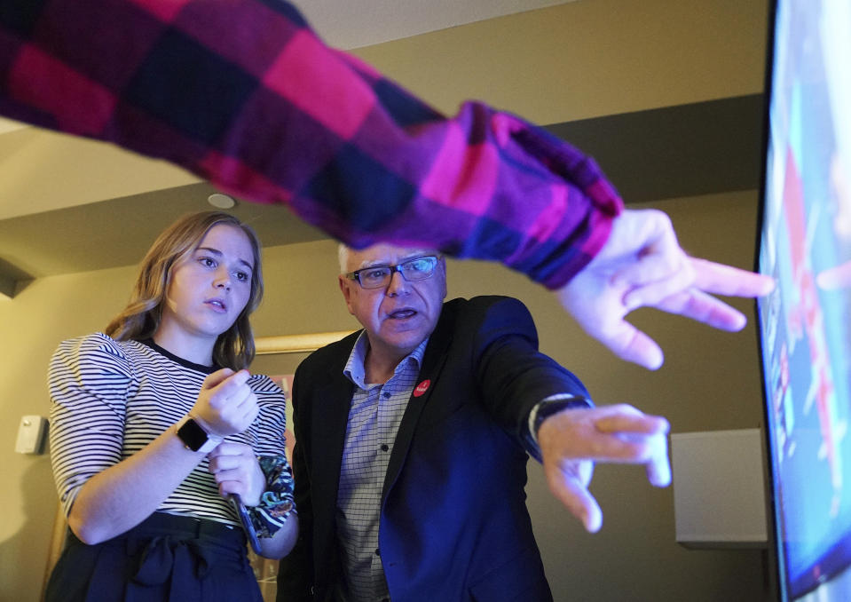 Tim Walz, a Democratic-Farmer-Labor gubernatorial candidate, watches election results with his extended family in their hotel suite at the Intercontinental Hotel in downtown St. Paul, Minn., Tuesday, Nov. 6, 2018. DFL candidates, officials and supporters gathered for the election watch party at the hotel. (Anthony Souffle/Star Tribune via AP)