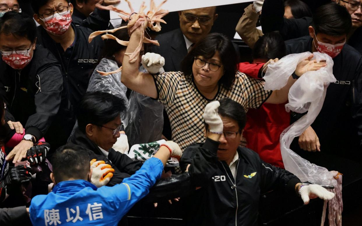 Taiwan lawmakers throw pork intestines at each other during a scuffle in the parliament in Taipei, Taiwan - REUTERS