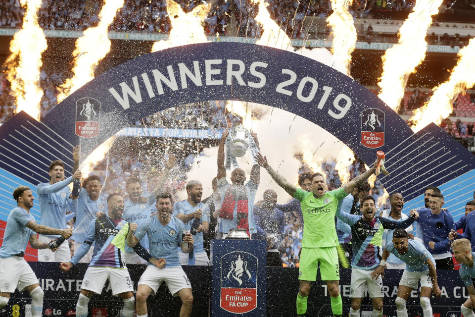 Manchester City's team captain Vincent Kompany lifts the trophy after winning the English FA Cup Final soccer match between Manchester City and Watford at Wembley stadium in London, Saturday, May 18, 2019. Manchester City won 6-0. (AP Photo/Tim Ireland)