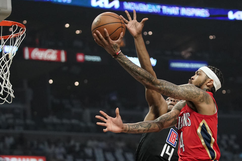 New Orleans Pelicans forward Brandon Ingram, right, shoots as Los Angeles Clippers guard Terance Mann defends during the first half of an NBA basketball play-in tournament game Friday, April 15, 2022, in Los Angeles. (AP Photo/Mark J. Terrill)