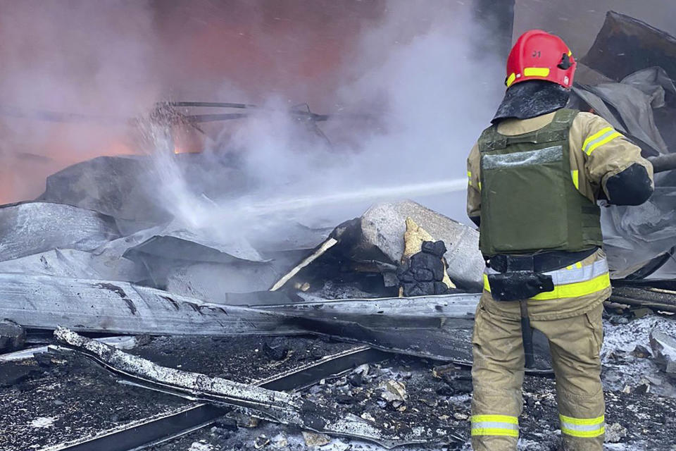 In this photo provided by the Ukrainian Emergency Service, a firefighter works to extinguish a fire after a Russian missile attack in Kryvyi Rih, Ukraine, Monday, Jan. 8, 2024. (Ukrainian Emergency Service via AP)