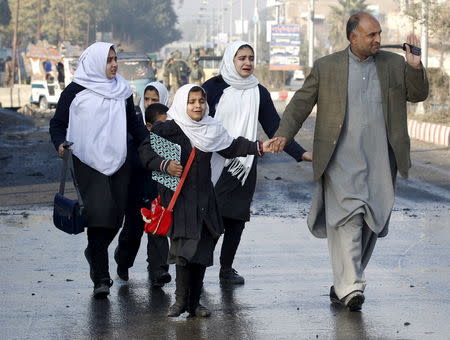 School children react as they were led away after a blast near the Pakistani consulate in Jalalabad, Afghanistan January 13, 2016. REUTERS/Parwiz -