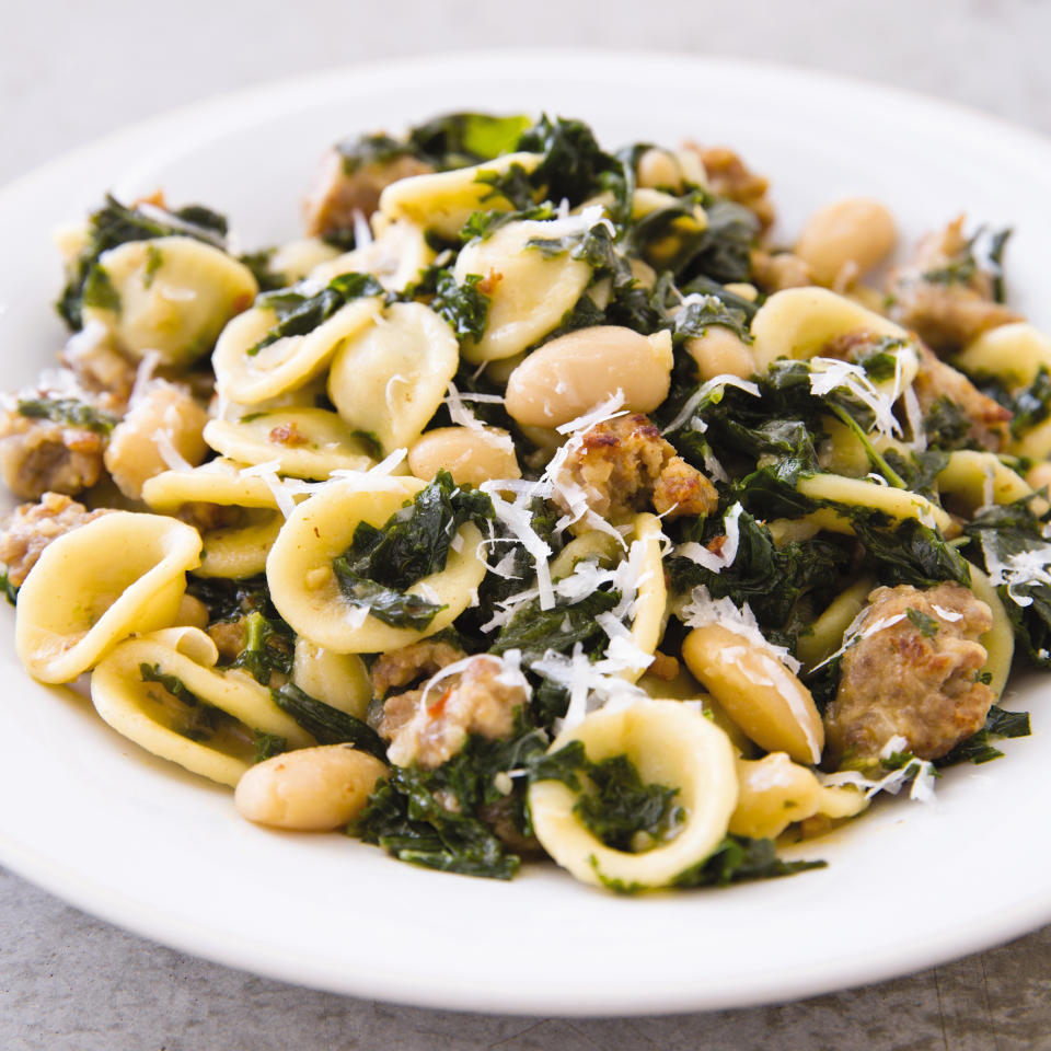 This undated photo provided by America's Test Kitchen in September 2018 shows pasta with sausage, kale and white beans in Brookline, Mass. This recipe appears in the cookbook “One-Pan Wonders.” (Joe Keller/America's Test Kitchen via AP)