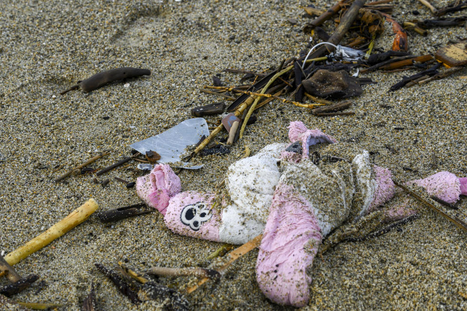 Personal belongings among the wreckage of a capsized boat washed ashore at a beach near Cutro, southern Italy, Monday, Feb. 27, 2023. Nearly 70 people died in last week's shipwreck on Italy's Calabrian coast. The tragedy highlighted a lesser-known migration route from Turkey to Italy for which smugglers charge around 8,000 euros per person. (AP Photo/Valeria Ferraro, File)