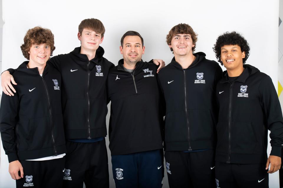 West York basketball head coach Garrett Bull (center) poses for a photo with players (from left) Brendan Kern, Kevin Rill, Jacob Knisley and Mark Walker during YAIAA winter sports media days Wednesday, November 8, 2023, in York.