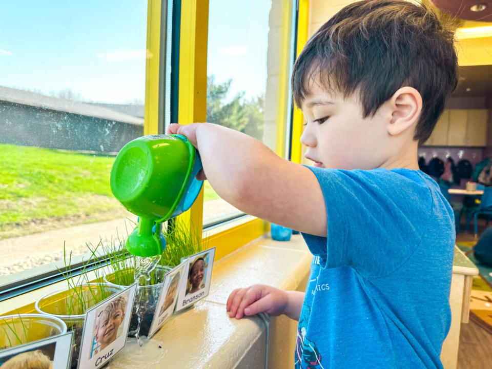 A child waters plants at the Boys and Girls Club in Brookings. (Courtesy of the Boys and Girls Club of the Northern Plains)