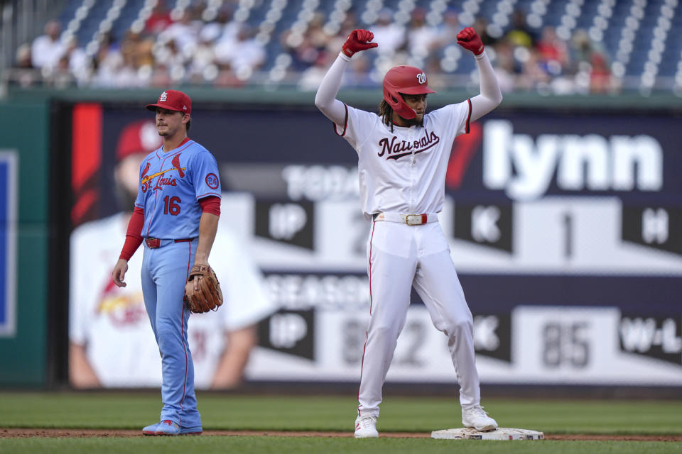 Washington Nationals' James Wood, right, reacts after hitting a two-RBI double during the third inning of a baseball game against the St. Louis Cardinals at Nationals Park, Saturday, July 6, 2024, in Washington. At left is St. Louis Cardinals second baseman Nolan Gorman (16). (AP Photo/Mark Schiefelbein)