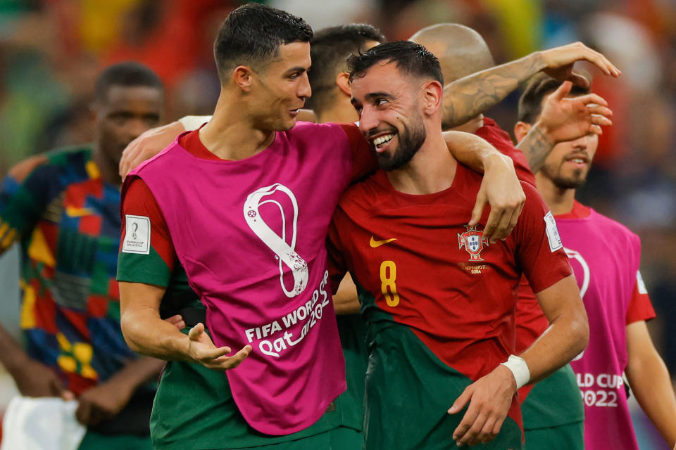 Portugal&#39;s Cristiano Ronaldo (L) and Bruno Fernandes celebrate after they won a Qatar 2022 World Cup group match against Uruguay. (ODD ANDERSEN/AFP via Getty Images)