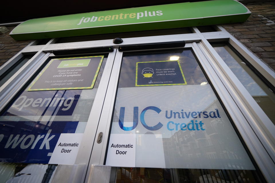 A Universal Credit sign on a door of a job centre plus in east London. Recipients of Universal Credit (UC) have described feeling 