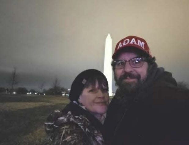 Christy and Matthew Clark of Pennsylvania posed for a photo in front of the Washington monument. They&#39;re among those charged by federal authorities for their participation in the Capitol riot.