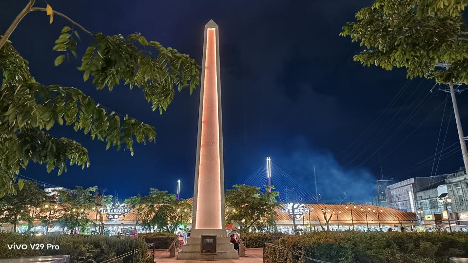 A towering city monument standing tall amidst the bustling urban landscape