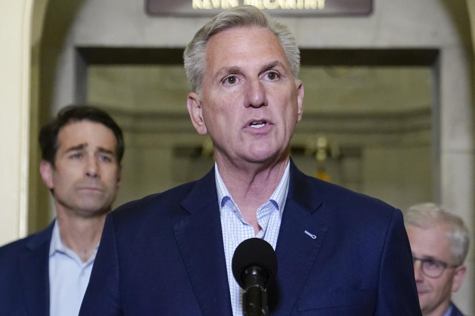 House Speaker Kevin McCarthy of Calif., speaks during a news conference after President Joe Biden and McCarthy reached an "agreement in principle" to resolve the looming debt crisis on Saturday, May 27, 2023, on Capitol Hill in Washington. Rep. Patrick McHenry, R-N.C., right, and Rep. Garret Graves, R-La., left, listen. (AP Photo/Patrick Semansky)