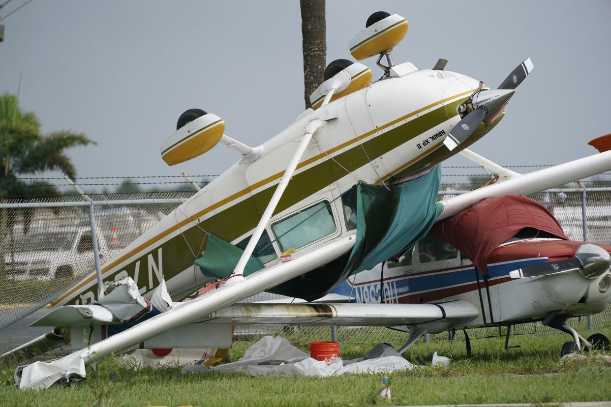 An airplane overturned by a likely tornado produced by the outer bands of Hurricane Ian is shown, Wednesday, Sept. 28, 2022, at North Perry Airport in Pembroke Pines, Fla.