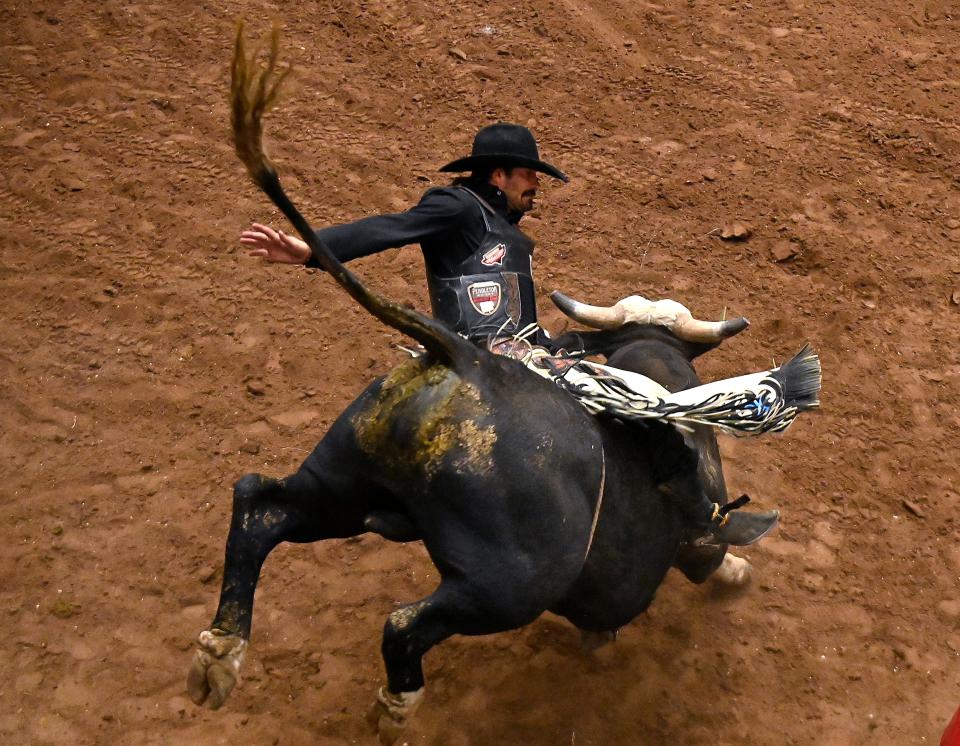 Elijah Mora of Wiggins, Colorado hangs on briefly to Richard Slam during the Bull Riding competition at the San Angelo Rodeo Friday April 5, 2024.