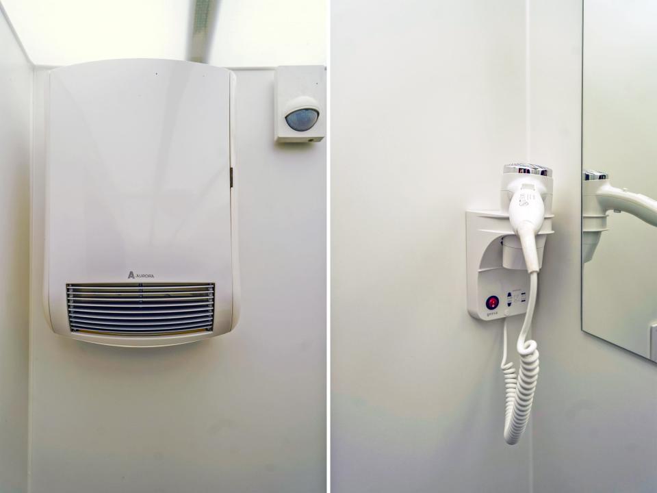 A heater (L) and a hair dryer (R) in the bathroom.