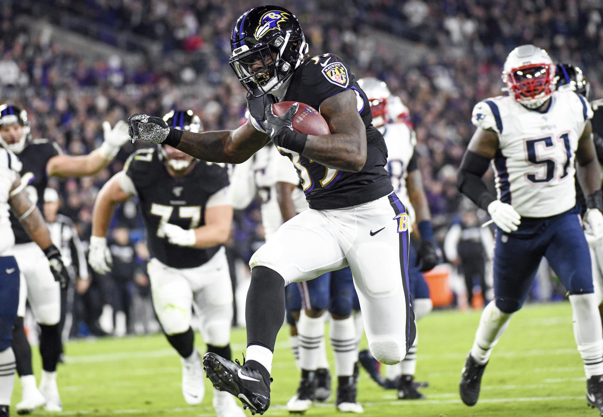 Baltimore Ravens running back Gus Edwards (35) runs for a 12-yard touchdown in the second quarter against the New England Patriots. (Getty Images)