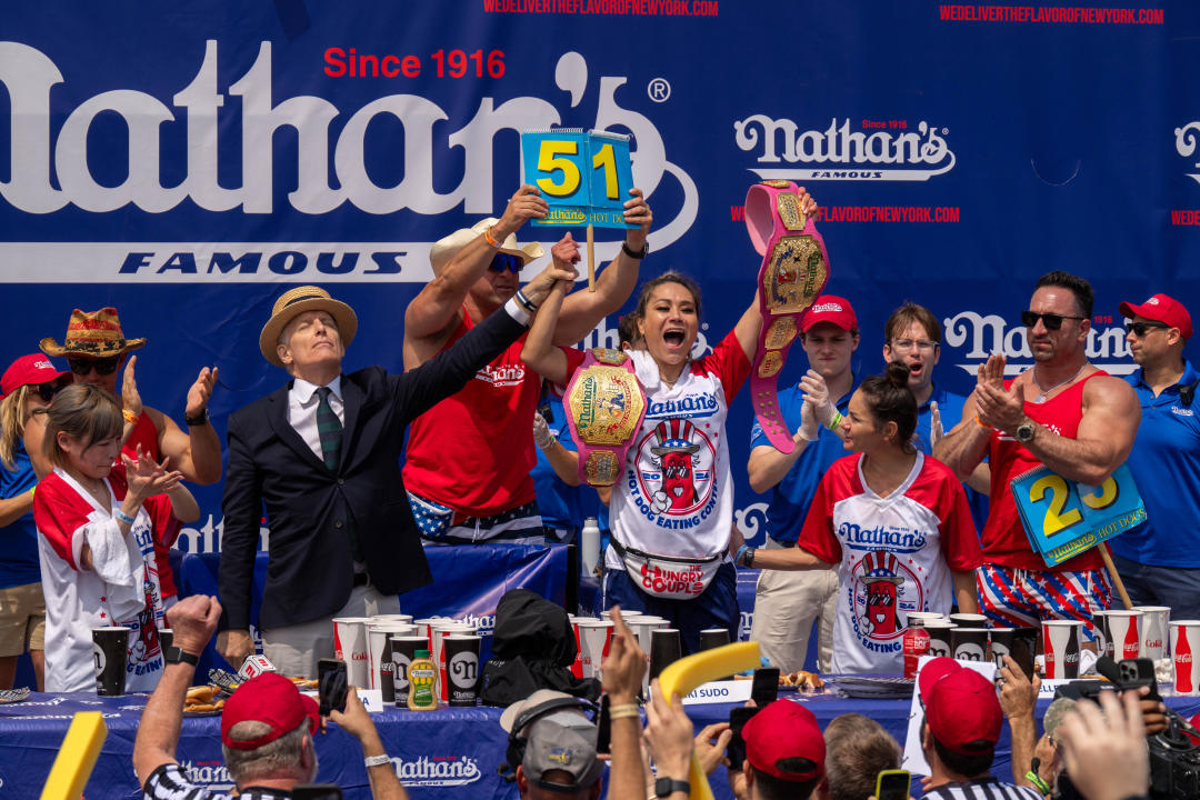 NEW YORK, NEW YORK - JULY 4: Miki Sudo wins the women's title with a record-breaking 51 hot dogs at Nathan's Annual Hot Dog Eating Contest on July 4, 2024 in New York City. Sixteen-time winner Joey Chestnut is banned from this year's contest due to his partnership with Nathan's competitor Impossible Foods, which sells plant-based hot dogs. (Photo by Adam Gray/Getty Images)