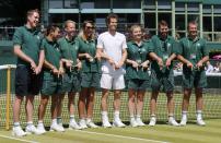 Andy Murray of Britain poses with groundstaff after a practice session at the Wimbledon Tennis Championships in London, July 9, 2015. REUTERS/Suzanne Plunkett