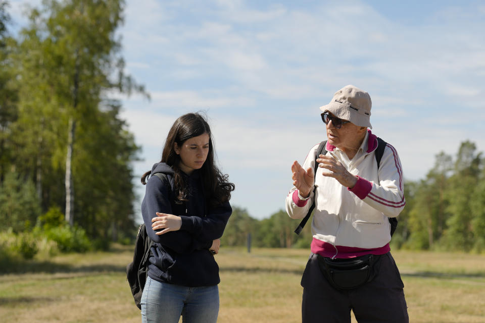 Israeli Olympic racewalker Shaul Ladany, right, talks to his granddaughter Raz Sharifi, at the former Nazi concentration camp Bergen-Belsen in Bergen, Germany, Saturday, Sept. 3, 2022. Shaul Ladany survived a Nazi concentration camp and narrowly escaped the massacre of the Israeli athletes at the 1972 Olympic Games in Munich. Both attempts to murder him happened on German soil in the last century. Many decades later, the 86-year-year old Jew has returned to visit the two places where he narrowly escaped death. (AP Photo/Markus Schreiber)