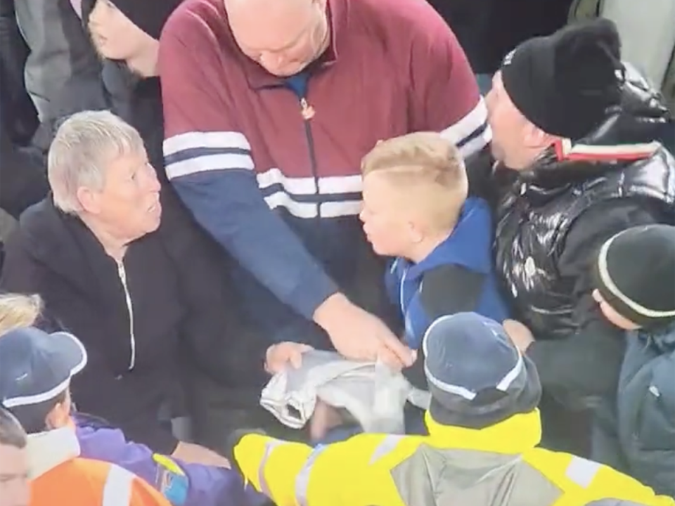 Paula Dodds, NJ, and two men wrestle over the Newcastle jersey (Jtrimble12)