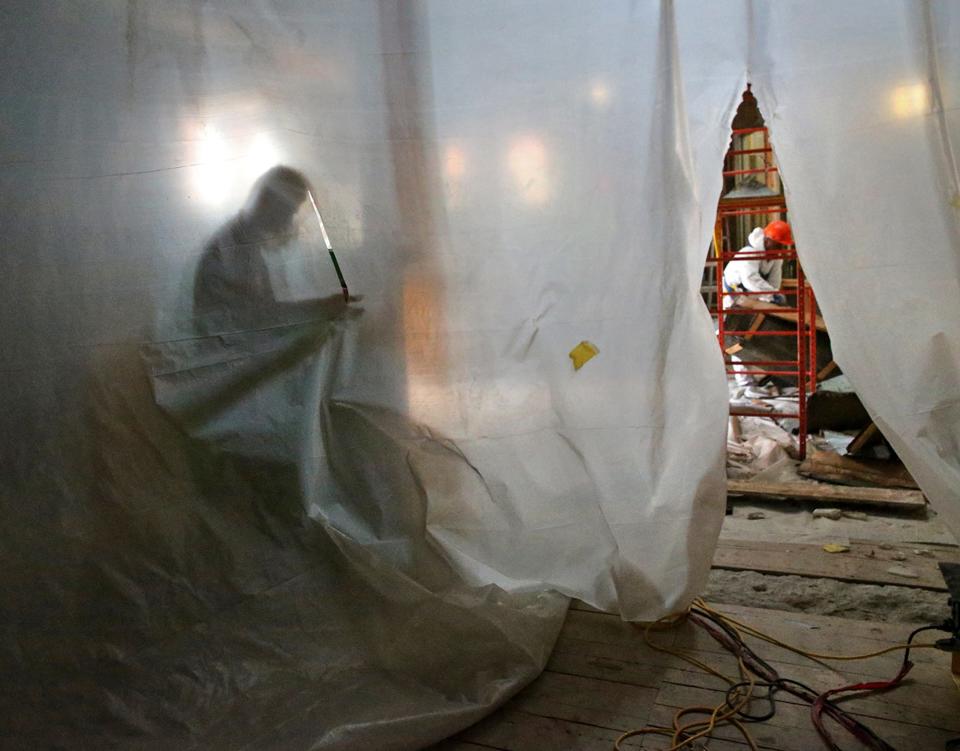 Porstmouth Brewery manager Jeff Hames is silhouetted against a plastic backdrop as crews work Monday, July 24, 2023 on the heavily damaged eatery due to a burst sprinkler pipe in June.