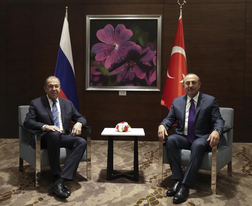 Turkey's Foreign Minister Mevlut Cavusoglu, right, and his Russian counterpart Sergey Lavrov pose for photographs prior to their meeting in the Mediterranean coastal city of Antalya, Turkey, Friday, March 29, 2019. The two ministers attending the Turkey - Russia Joint Strategic Group Meeting comes ahead of municipal elections scheduled to be held across Turkey on Sunday March 31. (Turkish Foreign Ministry via AP, Pool)