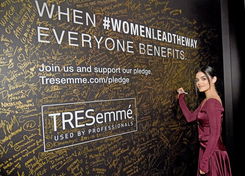 Lucy Hale adds her name to the wall at the TRESemmé Salon during New York Fashion Week at Spring Studios.