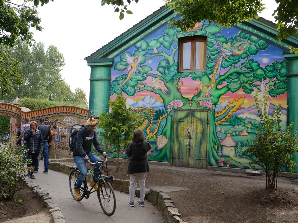 People admire a mural inside Christiania in 2016.