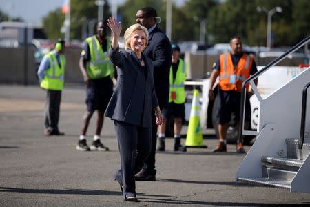 U.S. Democratic presidential candidate Hillary Clinton waves as she boards her campaign plane in Washington, U.S., September 16, 2016. REUTERS/Carlos Barria