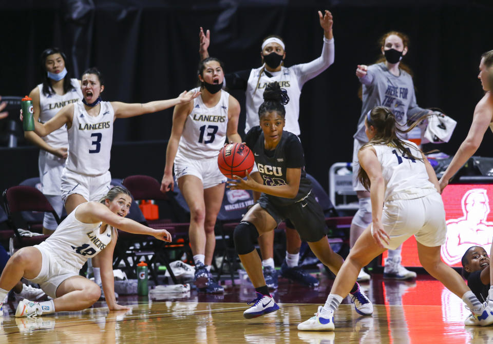 Grand Canyon's Tianna Brown (23) drives the ball under pressure from California Baptist's Sydney Palma (14) during the first half of an NCAA college basketball game for the championship of the Western Athletic Conference women's tournament Saturday, March 13, 2021, in Las Vegas. (AP Photo/Chase Stevens)