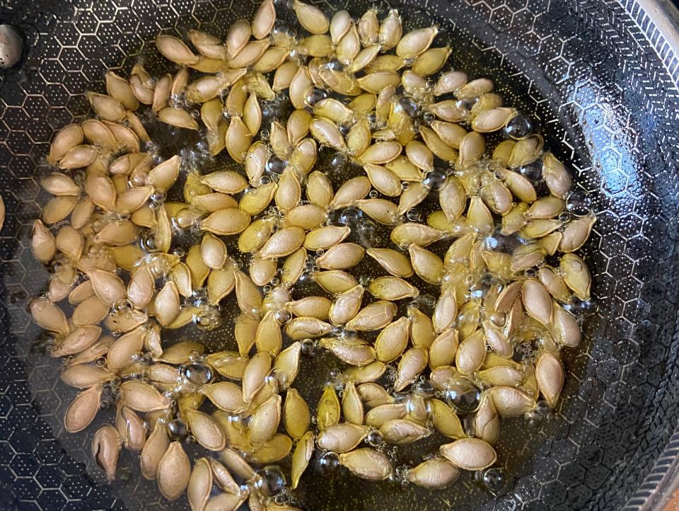 Butternut-squash seeds in a pan with oil