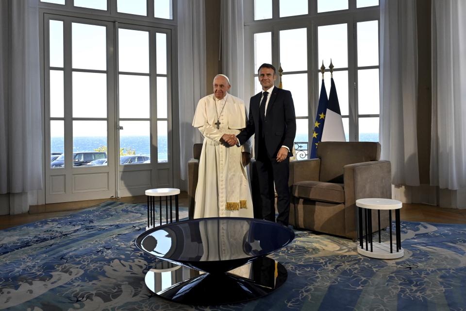 Pope Francis meets French President Emmanuel Macron at the Palais du Pharo, in Marseille, France, Saturday, Sept. 23, 2023. Francis, during a two-day visit, will join Catholic bishops from the Mediterranean region on discussions that will largely focus on migration. (Andreas Solaro/AFP via AP, Pool)