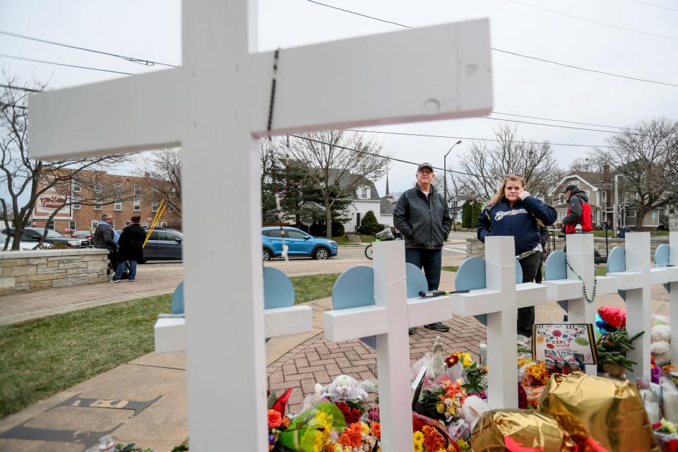 People come and go paying their respects Wednesday at Veterans Memorial Park to remember those killed in the Waukesha Christmas Parade on Sunday, Nov. 21, 2021.