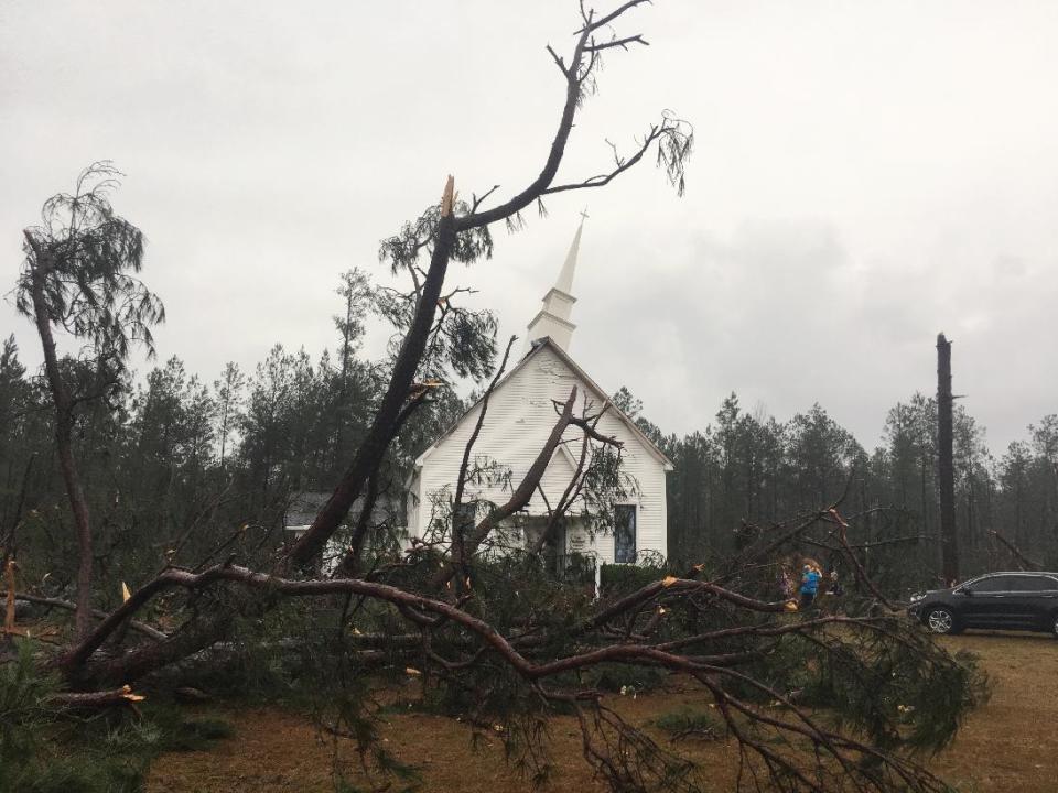 Fallen trees sit near Zoar United Methodist Church that sustained damage to its steeple Sunday, Jan. 22, 2017, near Baxley, Georgia. The National Weather Service said Sunday that southern Georgia, northern Florida and the corner of southeastern Alabama could face "intense and long track" tornadoes, scattered damaging winds and large hail. (AP Photo/Lewis Levine)