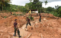 <p>Sri Lankan soldiers carry out recovery work at the site of a mudslide in the Kiribathgala village in Ratnapura district on May 31, 2017. Sri Lanka pledged May 31 to tighten construction laws as the toll from heavy rains rose, saying many landslide victims would have survived had their homes not been built on slopes. The government will also prosecute anyone violating existing rules by building on landslide-prone slopes, said Disaster Management Minister Anura Yapa. (Ishara S. Kodikara/AFP/Getty Images) </p>