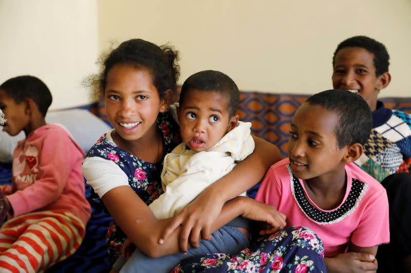 Mibrak Hailu, who says her parents were killed by Eritrean soldiers sits with her five siblings in a temporary house, in the Tigray region