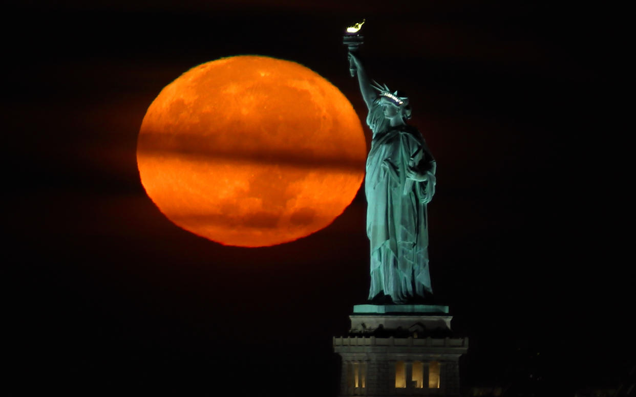 While harvest moons happen every year, this one will converge with a supermoon and partial lunar eclipse. (Gary Hershorn/Getty Images)