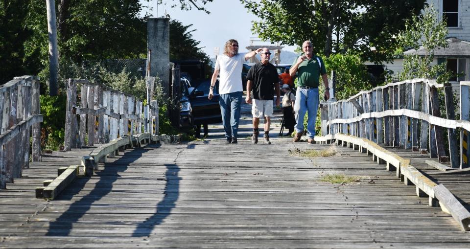 Ernie Boch Jr. tours Pleasure Island in Swansea on Tuesday, Aug. 30, 2022. Ernie Bock walks the bridge to the island with Michael Holland, director of properties and logistics, and Bill Dunn, owner of Consider it Dunn, Inc.