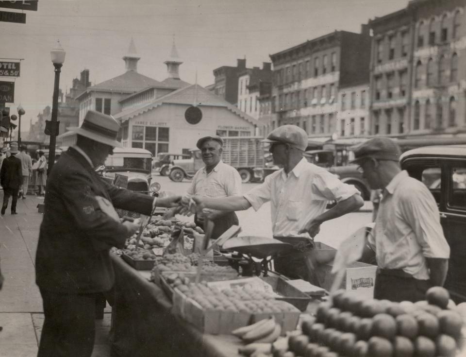 Produce stands line the curbs at the Sixth Street Market, leading to the Jabez Elliott Flower Market.