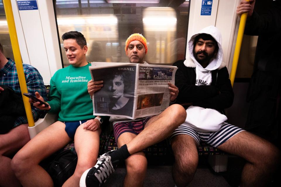 A man reading the Guardian on the Circle line. Other newspapers are available. (PA)