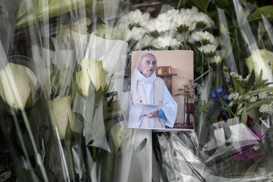 <p>A picture of late Father Jacques Hamel is placed on flowers at the makeshift memorial in front of the city hall closed to the church where an hostage taking left a priest dead the day before in Saint-Etienne-du-Rouvray, Normandy, France, Wednesday, July 27, 2016. (AP Photo/Francois Mori)</p><p><br></p>