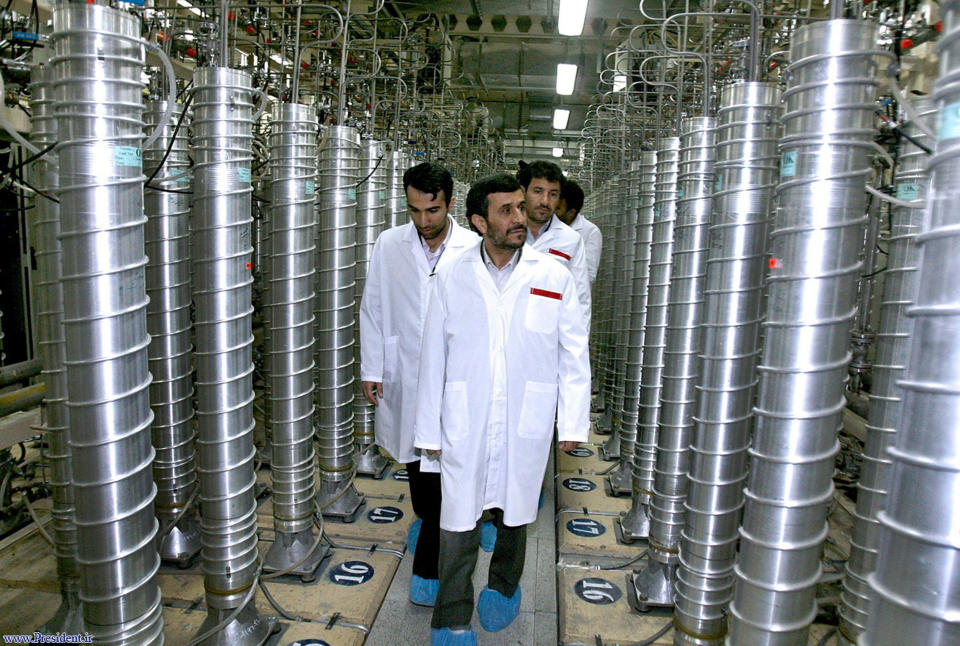 FILE - In this photo released by the Iranian President's Office, then-Iranian President Mahmoud Ahmadinejad, center, visits the Natanz Uranium Enrichment Facility near Natanz, Iran, April 8, 2008. A new underground facility at the Natanz enrichment site may put centrifuges beyond the range of a massive so-called “bunker buster” bomb earlier developed by the U.S. military, according experts and satellite photos analyzed by The Associated Press in May 2023. (Iranian President's Office via AP, File)