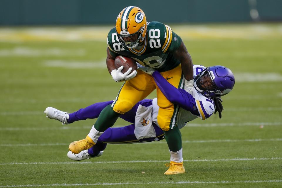 Minnesota Vikings' Harrison Hand stops Green Bay Packers' A.J. Dillon during the second half of an NFL football game Sunday, Nov. 1, 2020, in Green Bay, Wis. (AP Photo/Matt Ludtke)
