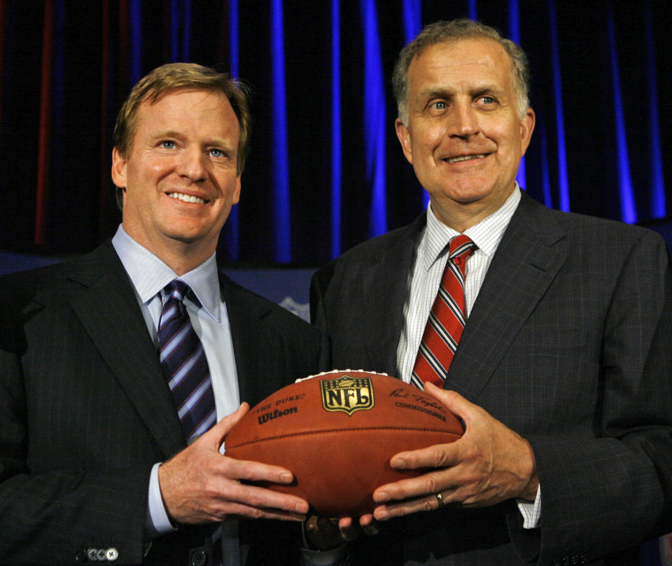 FILE - In this Aug. 8, 2006 file photo, Roger Goodell, left, the NFL's chief operating officer, and Paul Tagliabue, NFL commissioner, pose for photos after Goodell was selected to succeed Tagliabue as the league's new commissioner at an NFL meeting in Northbrook, Ill. The players' union opposes former Commissioner Tagliabue hearing the appeals of the four players suspended in the Saints bounties case. In a statement Wednesday, Oct. 24, 2012, the NFL Players Association said it will file a motion in U.S. District Court in New Orleans later in the day asking Tagliabue to recuse himself because of a conflict of interest. (AP Photo/M. Spencer Green, File)