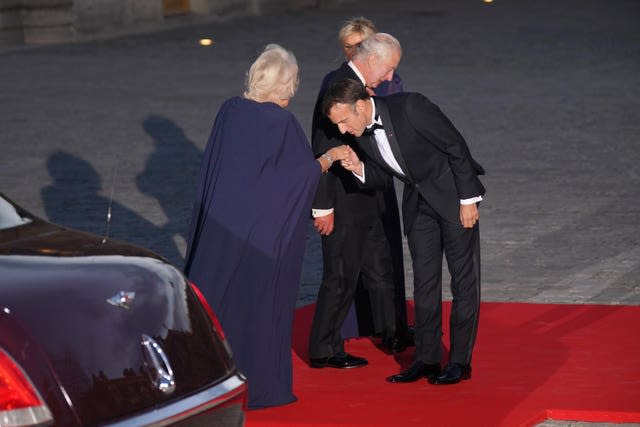 Emmanuel Macron kisses Queen Camilla’s hand as she and the King arrived for the banquet