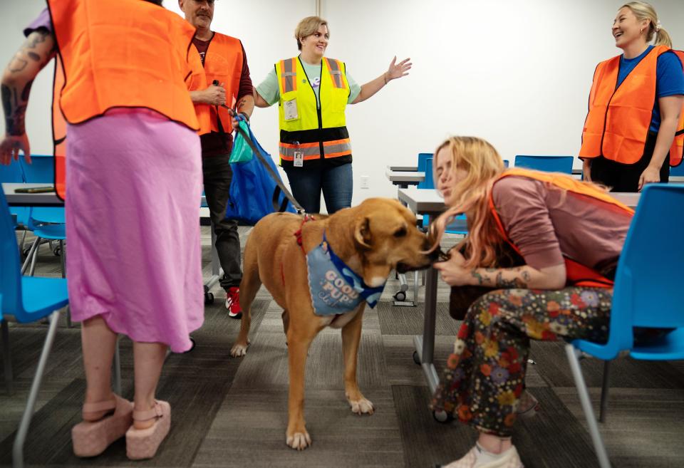 Catie Hydeman, top center, vice president of fulfillment operations at Chewy, kicks off a media tour at the company's Wilson County facility on June 14. Also along for the tour was Appa, a yellow Labrador-Great Pyrenees mix, who is up for adoption at the Nashville Humane Association.