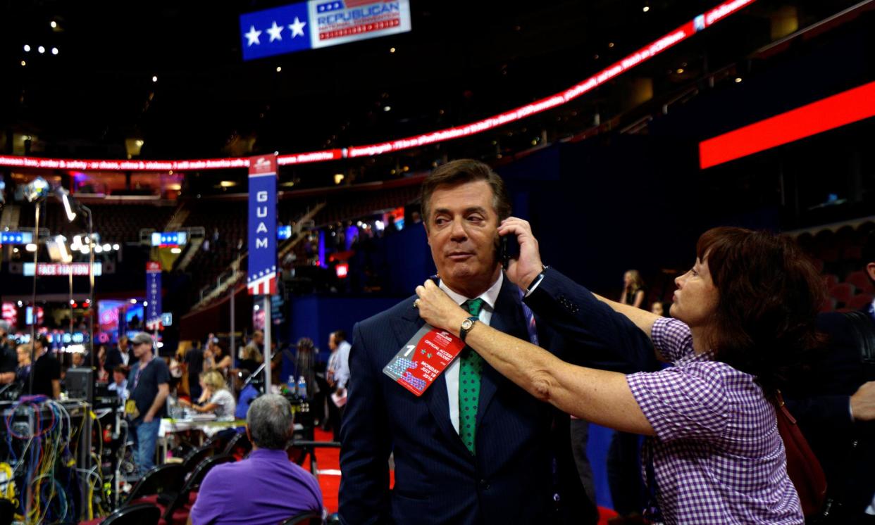 <span>Kathleen Manafort tries to put a credential on her husband Paul Manafort at the Republican national convention in Cleveland in 2016. He is expected to reprise his role as a Trump campaign adviser this year.</span><span>Photograph: Rick Wilking/Reuters</span>