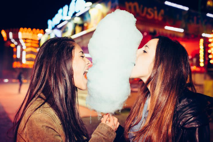 Two teenage girls eating cotton candy.<br>(Photo: Stocksy)