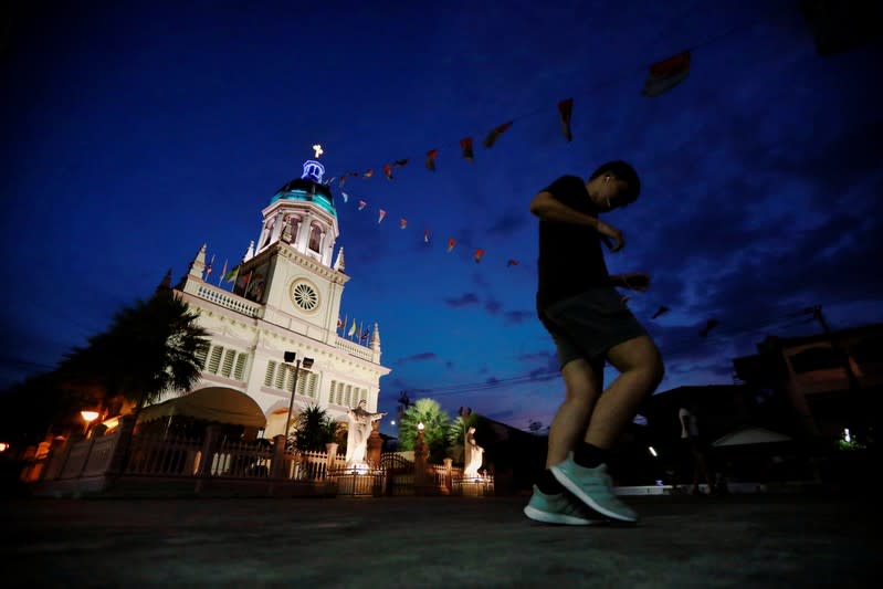 A man runs near Santa Cruz Church, ahead of Pope Francis' visit to Thailand, in Bangkok