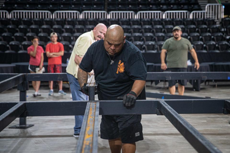 Duke It Out boxing coach Joe De La Paz and South Texas Amatuer Boxing Association President, Tom Lindsey, place support beams for a boxing ring at the American Bank Center on Thursday, June 9, 2022, in Corpus Christi, Texas. 